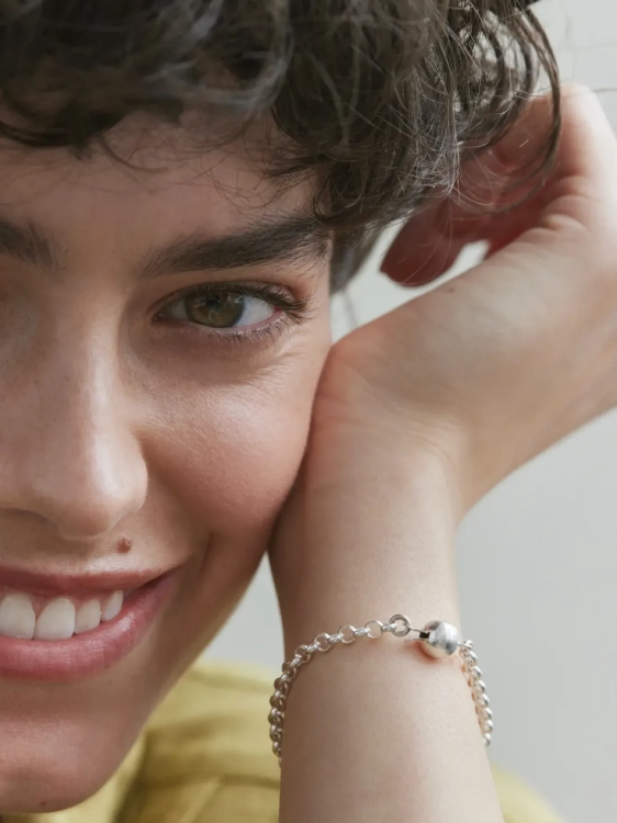 Nowoczesna bransoletka z grubym splotem idealnie leży na nadgarstku, podkreślając stylizację.